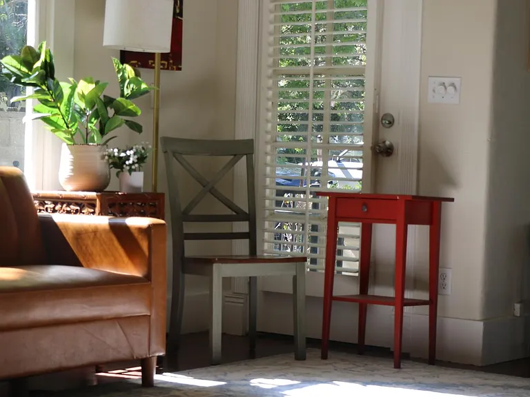 Living room looks out to Eureka Street and leafy trees.