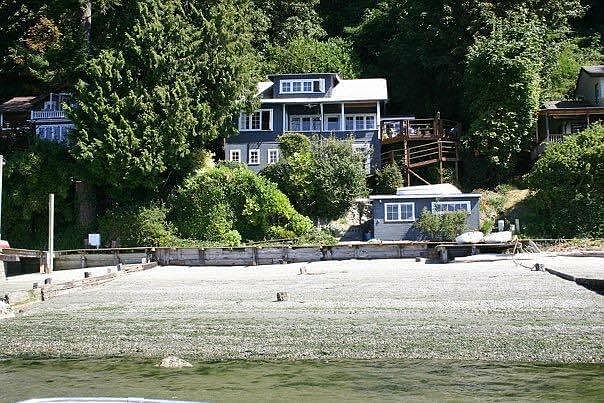 View from the beautiful, sandy beach. House above and boat house below