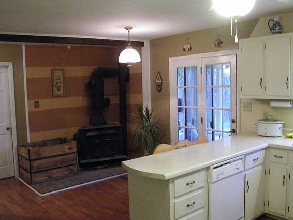 Kitchen with woodstove area, hardwood floors