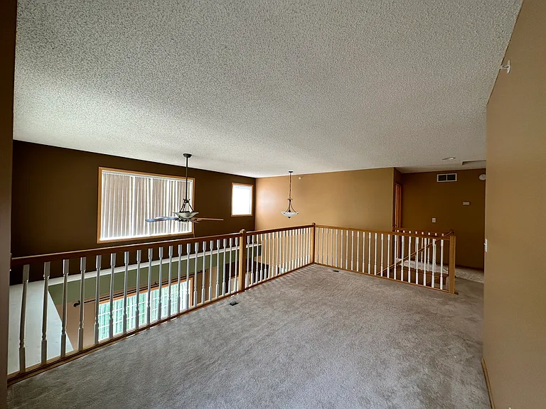 Large loft over looking the living room; can convert to den and office.