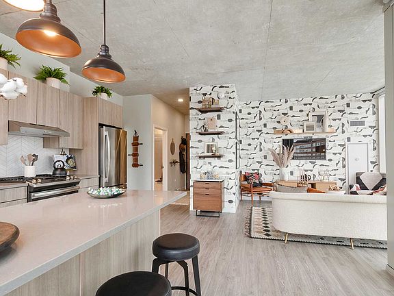 A seamless kitchen and living area creates an inviting space for everything from quiet mornings to nights spent entertaining.