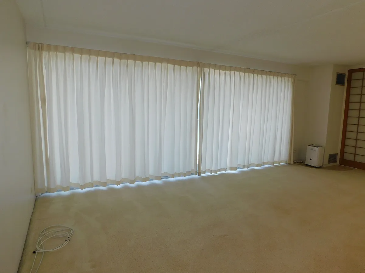 Living room sliding doors with curtains drawn. - 710 Lunalilo St #702