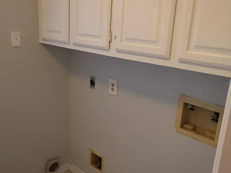 Utility room with hook-ups for your washer and dryer.