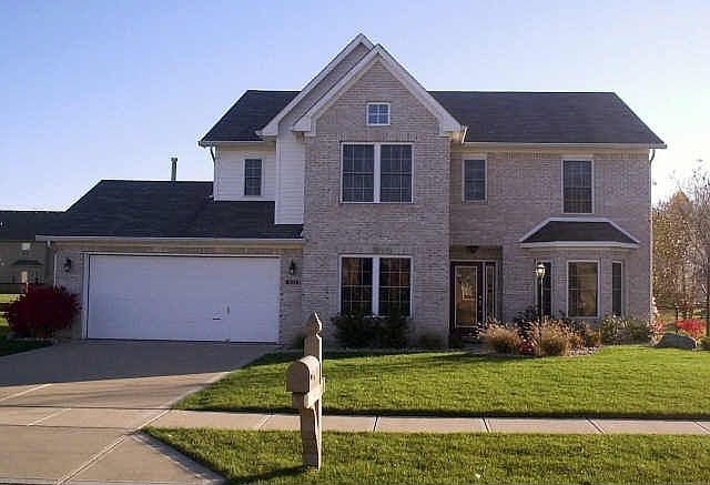 White brick front with a new beveled glass entry door.