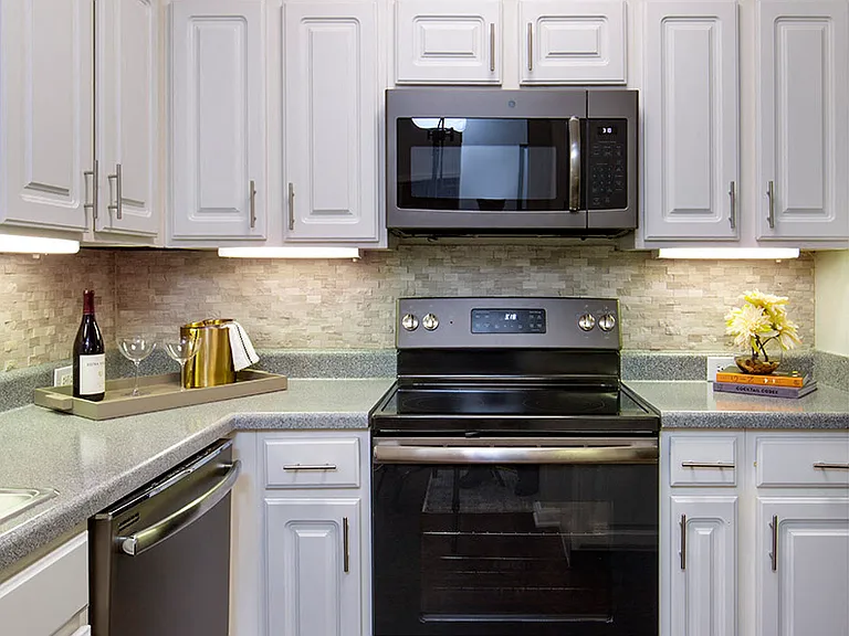 Kitchen with Slate Appliances and White Cabinetry