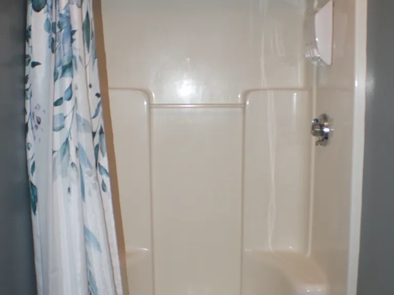 Bright, clean first_floor bathroom with a shower stall. Shared space kept tidy and well_maintained by homeowners.