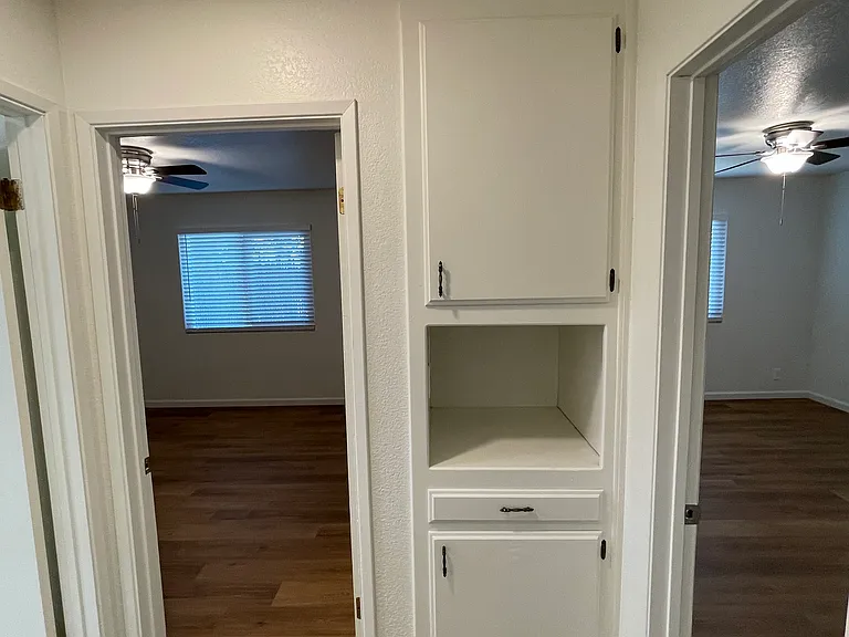 Hallway linen storage cabinetry.