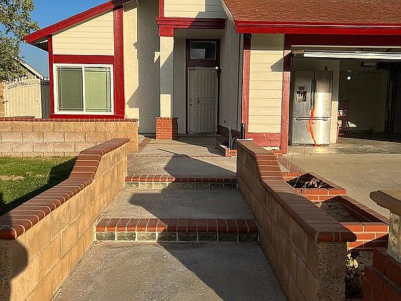 Front of house with beautiful brick work with lights on columns