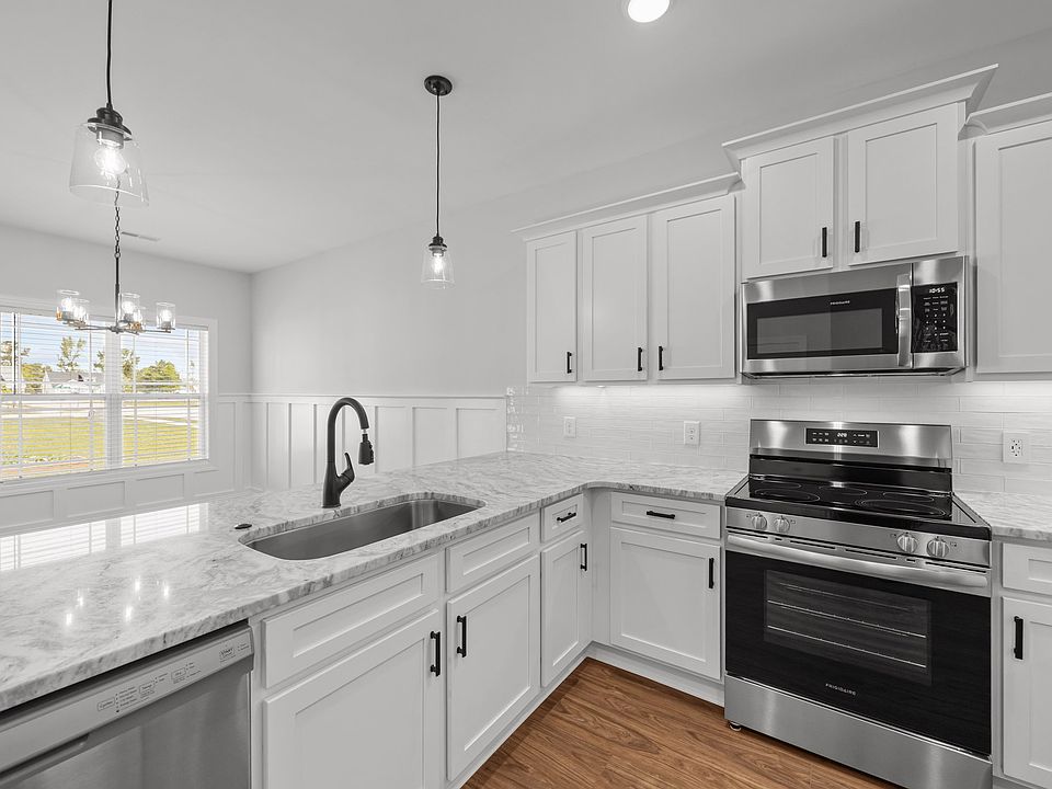 Kitchen with Stainless appliances bar overhang for eating and stools