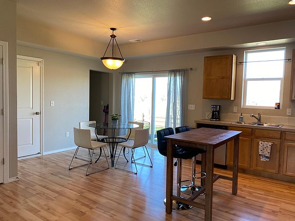 Hallway goes to powder room. Patio doors go to a large concrete patio that overlooks the fields and mountains.