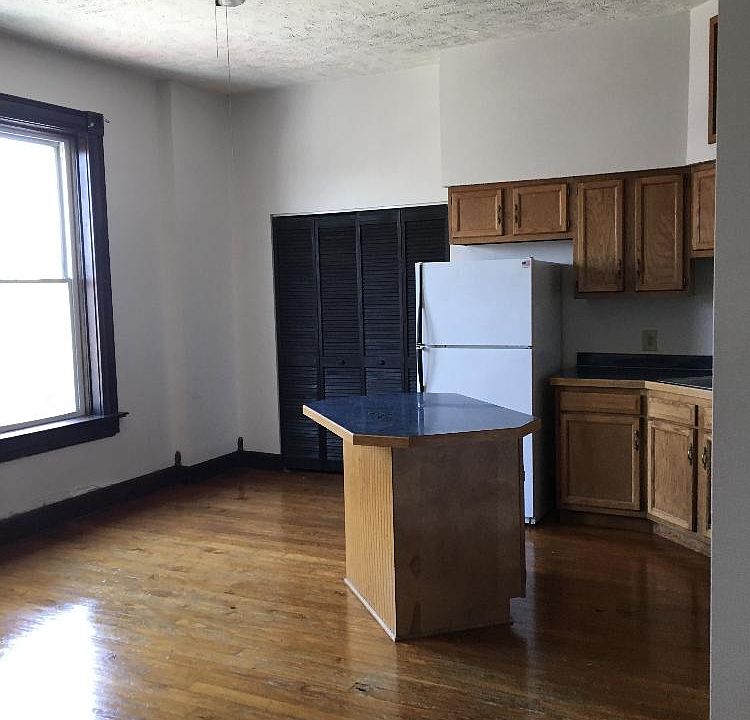 Open concept of full kitchen and living room.