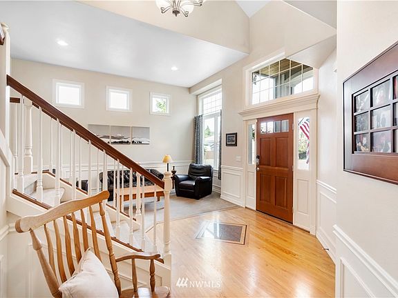 Gleaming hardwood flooring with granite inlays expands throughout this fantastic open floor plan