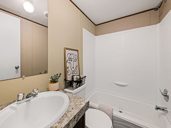 Hallways bathroom features full size tub.