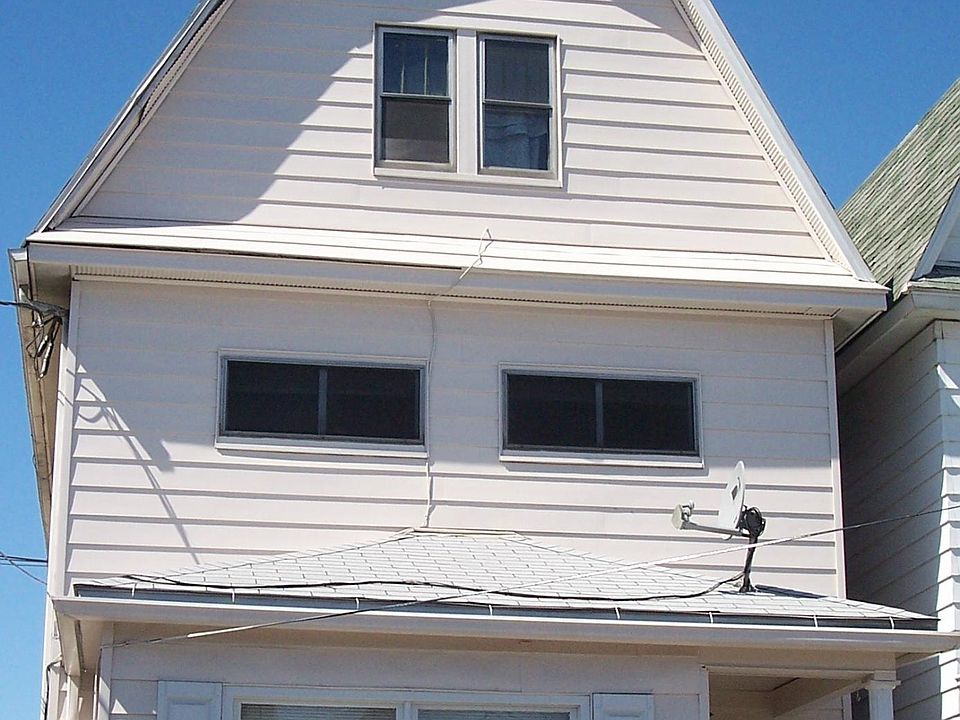 Outside of building; air conditioner is in living room window