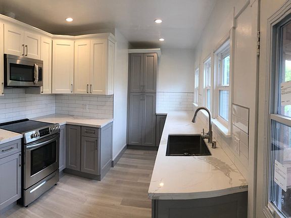 Kitchen - all (brand new) stainless appliances, electric stove/oven, microwave, quartz countertop with tons of storage and space