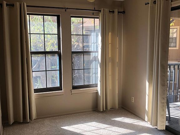 Lots of light. Dining area. Balcony to right. Curtains here are blackout. Curtains elsewhere filter light.