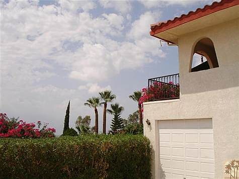 Balcony off of the dining area provides a sunset view and overlooks two 10,000 ft peaks and the city lights of Palm Springs in the Valley below.