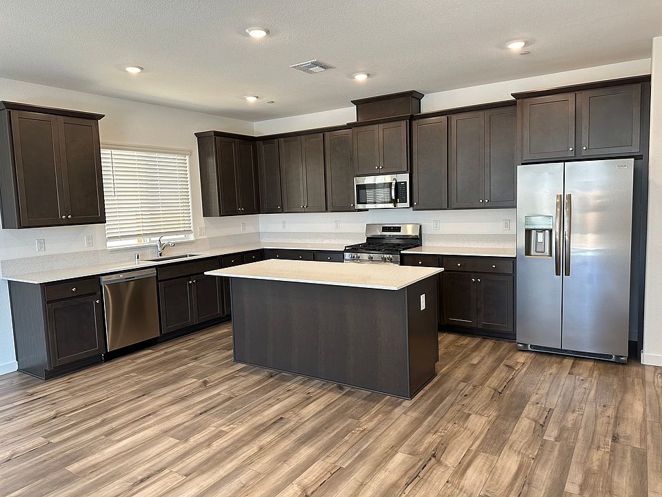 Modern kitchen with stainless steel appliances, offering plenty of counter space and cabinetry