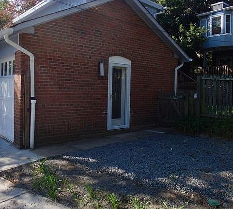 Exterior - entry door (patio now enclosed with a fence along the alley)