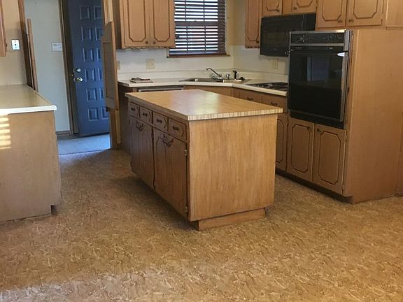 Kitchen from dining room. Front entry in the background. Island is moveable.