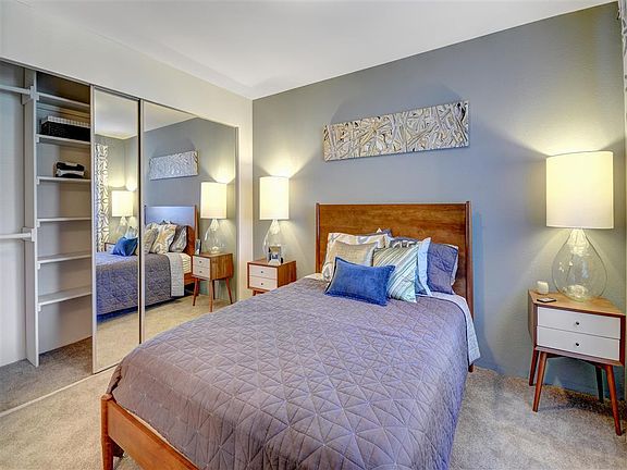 Large master suites feature mirrored closet doors