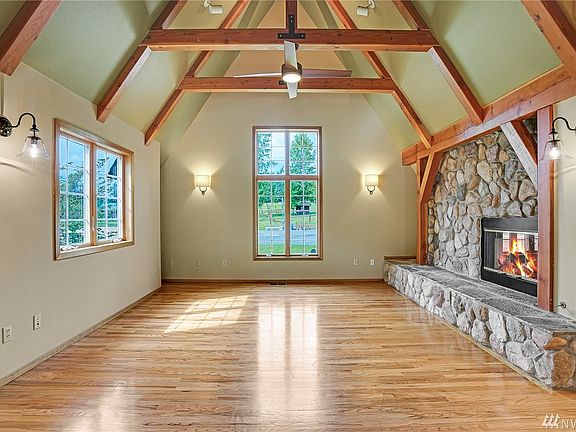 Stunning details such as a Montana River rock fireplace and open beams