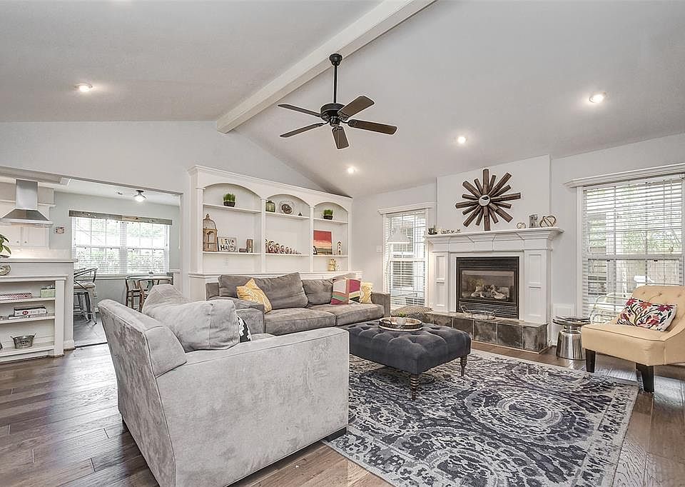 Large living space with vaulted ceilings. More built-ins and storage space. Gas burning fireplace. Lots of natural light.