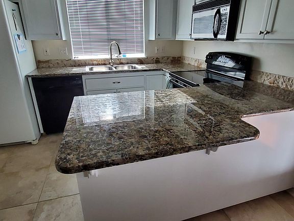 Kitchen with previous frig, it has a stainless side by side now