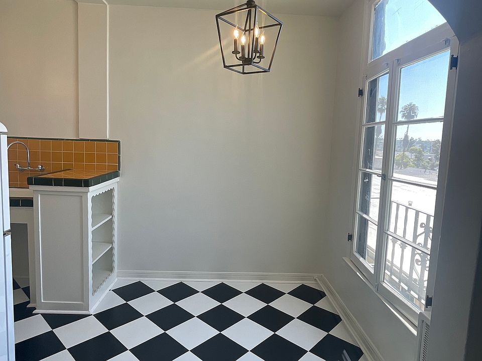 Looking into kitchen dining area from living room; new floor and lighting