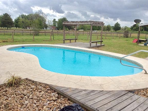 Front of home is to the left, garage in the middle and the awesome barn in back at the right