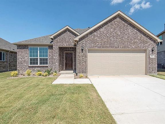 Front of home w/ long driveway. 2-car garage.
