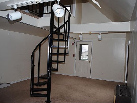 Living Room with circular stairway to loft bedroom