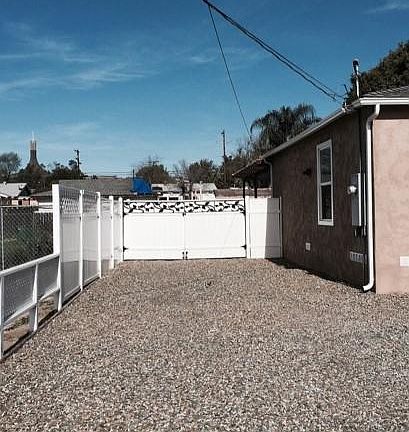 House left side parking area RV parking beyond gate