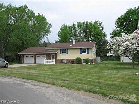 Very well maintained home with beautiful dogwoods, extra garage, storage shed, and pool.