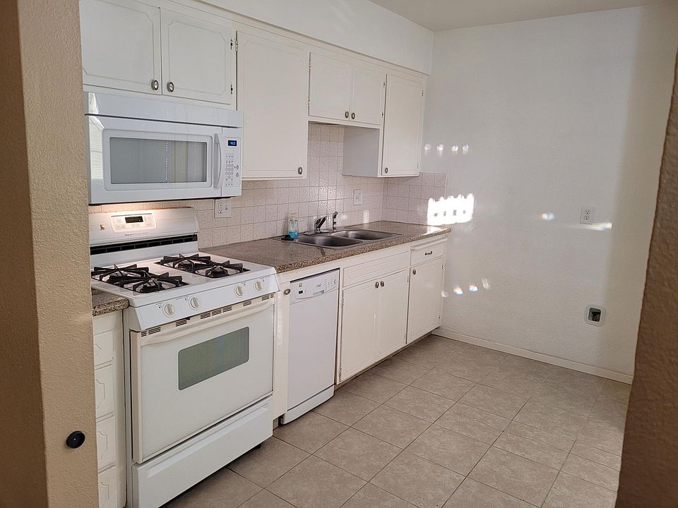 Kitchen with granite counters, stainless steel sink, gas range, microwave & dishwasher