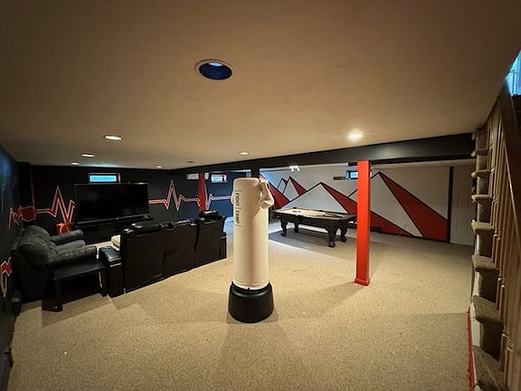 entertainment center with big-screen TV, pool table and bar