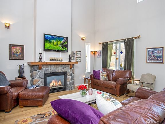 Soaring ceilings & beautiful newer wood floors in the living space.