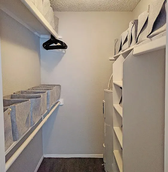 Walk-in closet with built-in shelving and extra storage space
