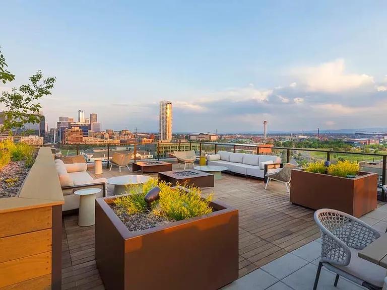 Rooftop deck with lush landscaping, fire pits, outdoor tv, plus city and mountain views.