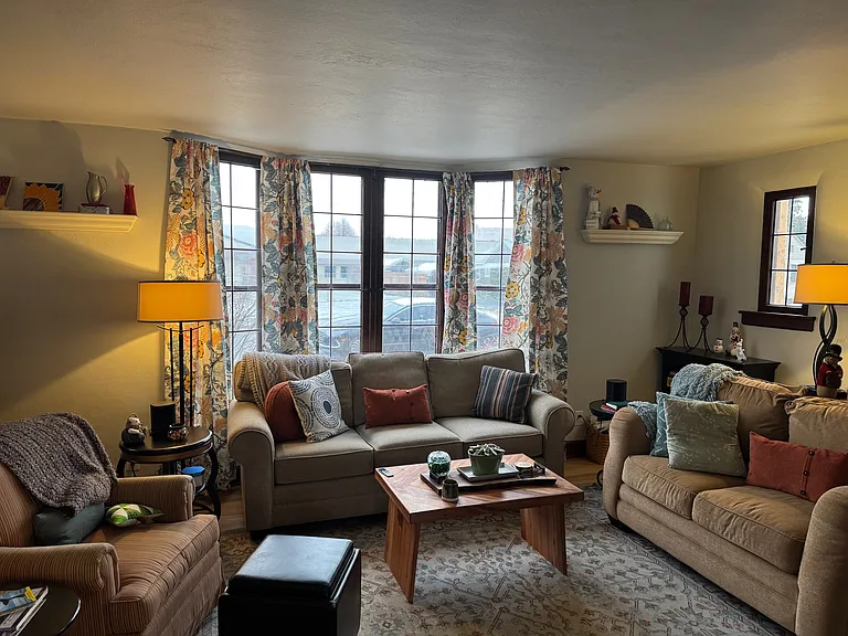 Living room with bay window and electric fireplace