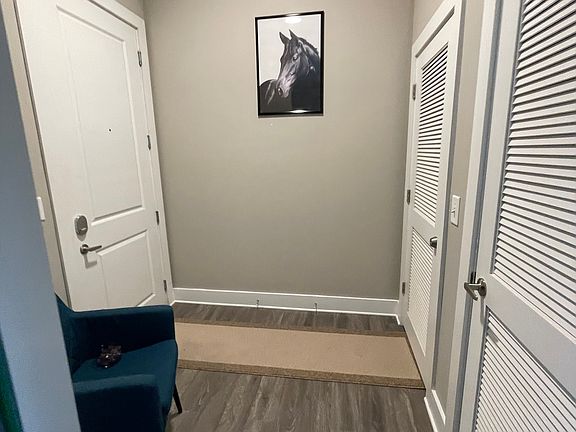 Spacious entry way with aqua accent chair