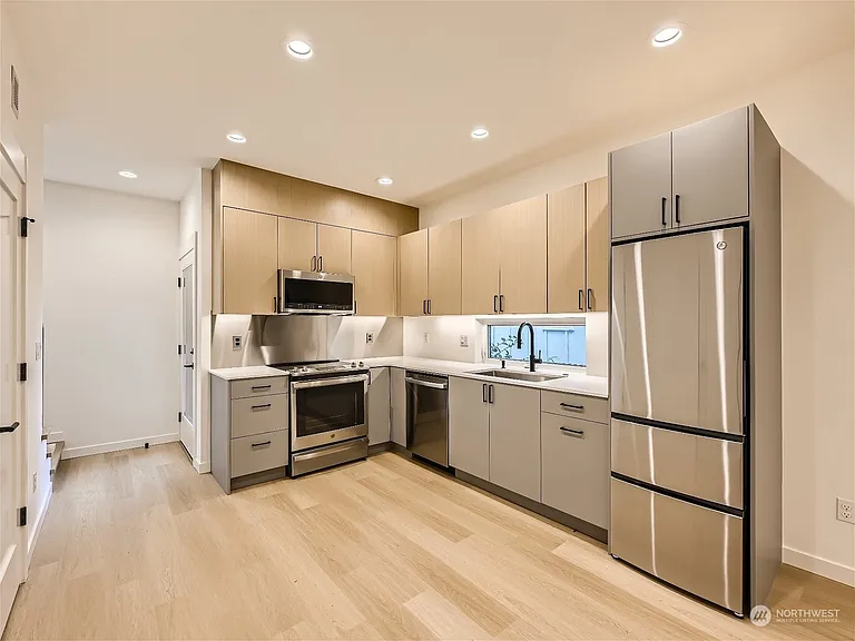 Kitchen. Fridge has been upgraded to an extra-large from pictured and cabinetry extended right 6 inches for additional storage!