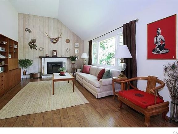 Living room with 14'+ vaulted ceiling. New Hickory flooring and freshly painted.Living room freshly 