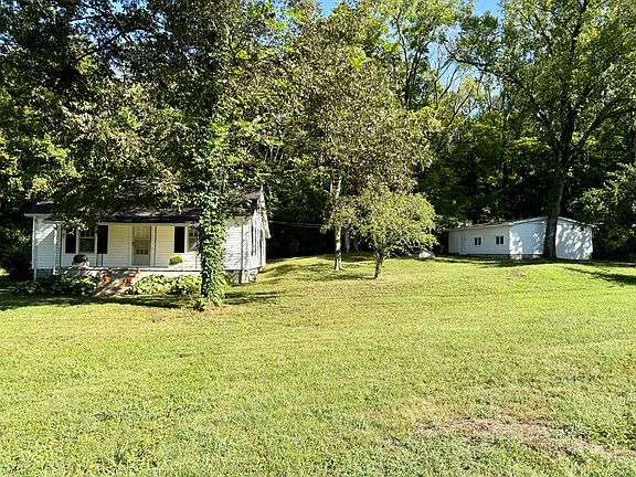 Beautiful property with the farm style house and a large garage and workshop