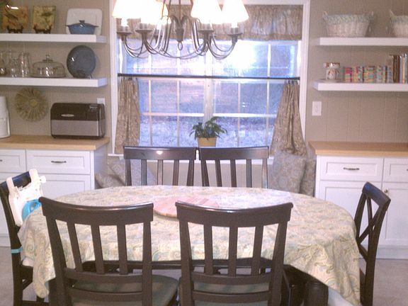 New cabinets, counters and shelves with bench seat under the window