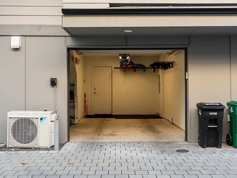 Attached one car garage with built in storage racks and additional hideaway space under the stairs