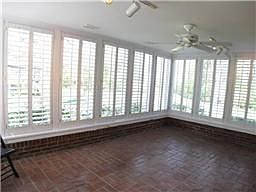 The den/sunroom looks over the huge backyard with walls of windows. 