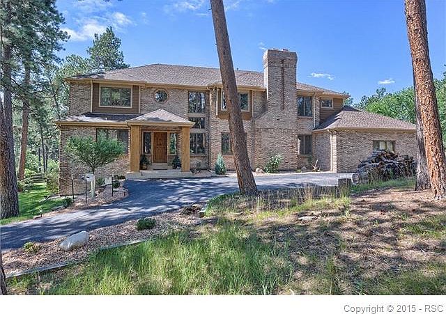Welcoming column-flanked entry off circular driveway