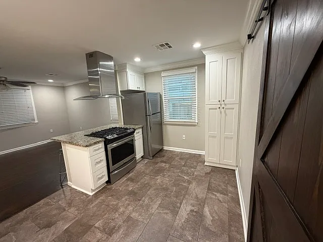 Recessed lighting in kitchen and living room is fully dimmable