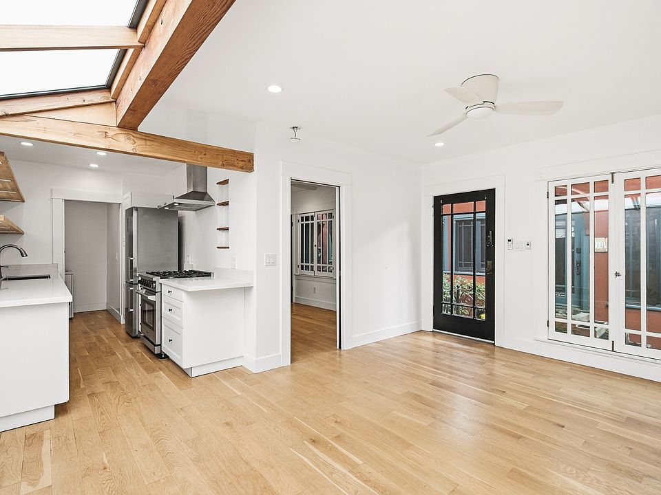 Living room with a view into the kitchen and bedroom door